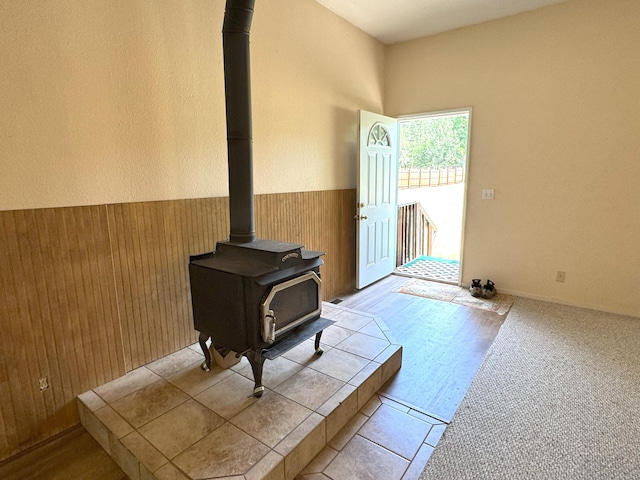 29093 Day Rd, Mcarthur, CA 96056 - unfurnished living room with a wood stove, wooden walls, and a wainscoted wall