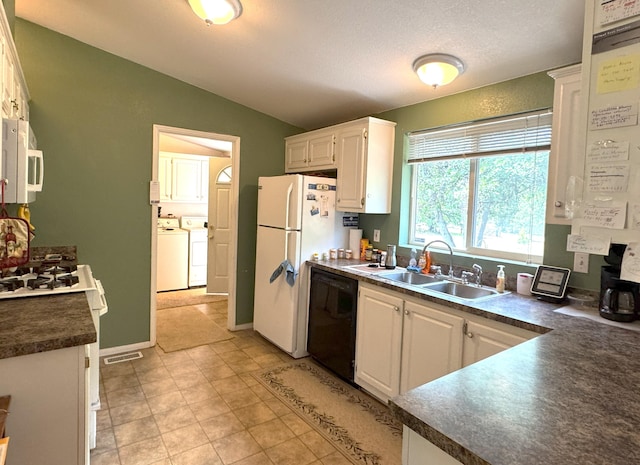 29093 Day Rd, Mcarthur, CA 96056 - kitchen with white appliances, separate washer and dryer, lofted ceiling, dark countertops, and white cabinets