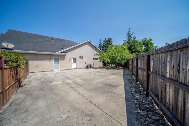 3921 Silver Lace Ln, Redding, CA 96001 - rear view of house with a fenced backyard, a patio, and stucco siding
