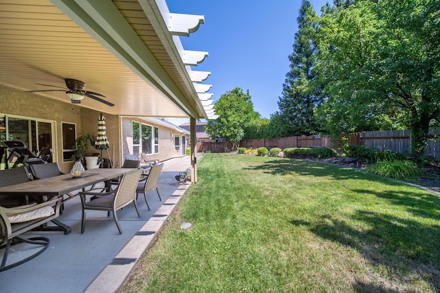 3921 Silver Lace Ln, Redding, CA 96001 - fenced backyard featuring a ceiling fan, a patio area, and outdoor dining area