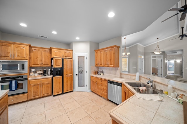 3921 Silver Lace Ln, Redding, CA 96001 - kitchen with built in appliances, ceiling fan, a peninsula, decorative backsplash, and recessed lighting