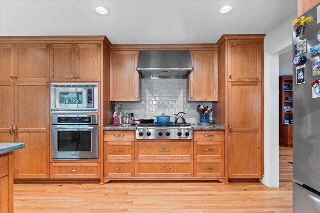 3141 Meadow Oak Dr, Cottonwood, CA 96022 - kitchen featuring appliances with stainless steel finishes, range hood, backsplash, brown cabinetry, and recessed lighting