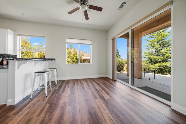 1005 Albion Ave, Redding, CA 96003 - unfurnished living room featuring dark wood-type flooring, a ceiling fan, and baseboards