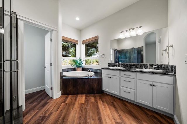 1005 Albion Ave, Redding, CA 96003 - full bathroom featuring double vanity, a garden tub, wood finished floors, a shower stall, and recessed lighting