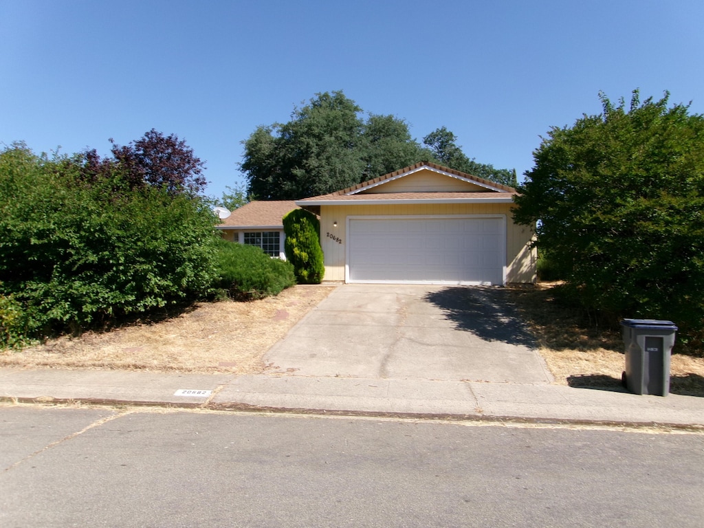 20682 Sigma Dr, Cottonwood, CA 96022 - ranch-style home with concrete driveway and a garage