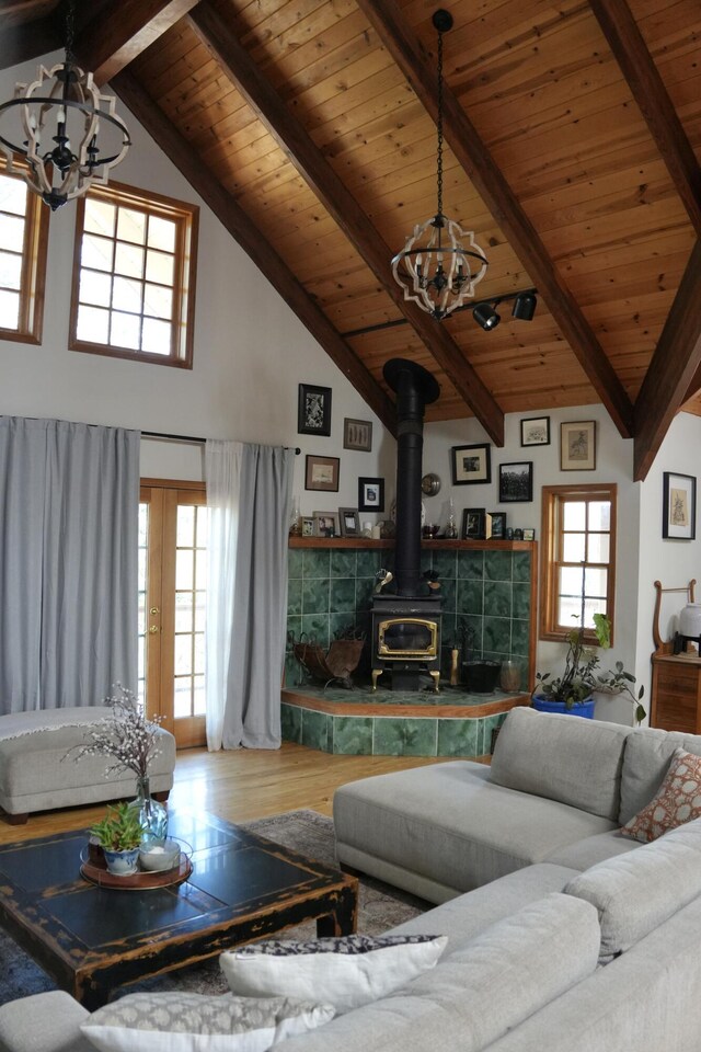 261 Salt Flat Rd, Lewiston, CA 96052 - living area with a chandelier, a wood ceiling with exposed beams, wood finished floors, a wood stove, and high vaulted ceiling