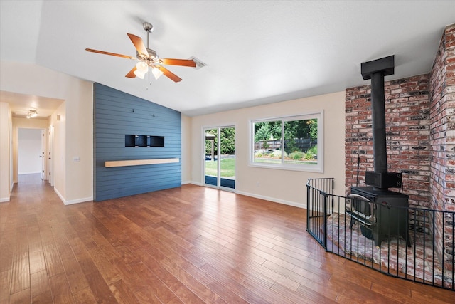 466 Tourmaline Way, Redding, CA 96003 - living area with a wood stove, vaulted ceiling, a ceiling fan, and wood finished floors