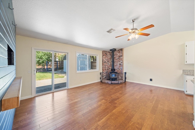 466 Tourmaline Way, Redding, CA 96003 - unfurnished living room featuring a wood stove, ceiling fan, light wood-style flooring, and lofted ceiling