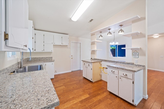 466 Tourmaline Way, Redding, CA 96003 - kitchen with open shelves, white cabinetry, lofted ceiling, light wood-style floors, and pendant lighting