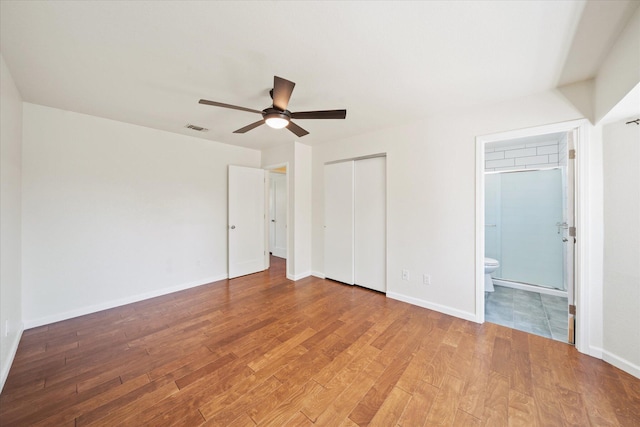 466 Tourmaline Way, Redding, CA 96003 - unfurnished bedroom featuring wood finished floors, ensuite bath, a ceiling fan, and a closet