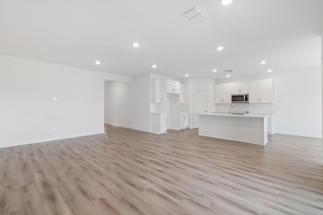 4206 Acadia Pl, Redding, CA 96001 - unfurnished living room with a sink, recessed lighting, light wood finished floors, and baseboards