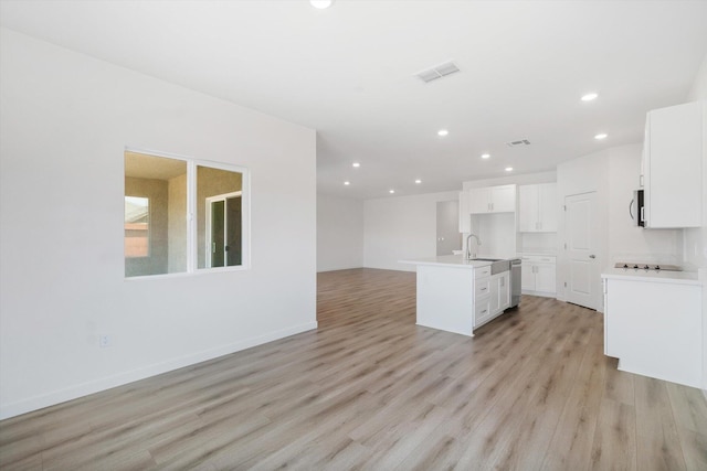4206 Acadia Pl, Redding, CA 96001 - kitchen featuring open floor plan, recessed lighting, light wood-type flooring, stainless steel appliances, and white cabinetry