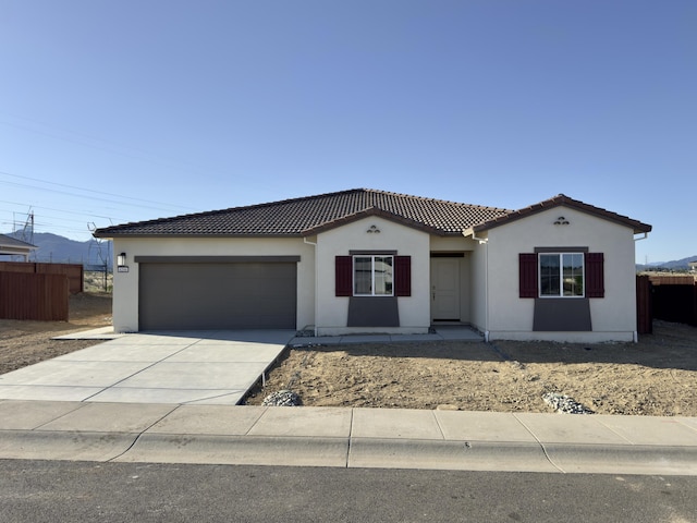 4206 Acadia Pl, Redding, CA 96001 - mediterranean / spanish-style home with a garage, a tiled roof, stucco siding, and driveway