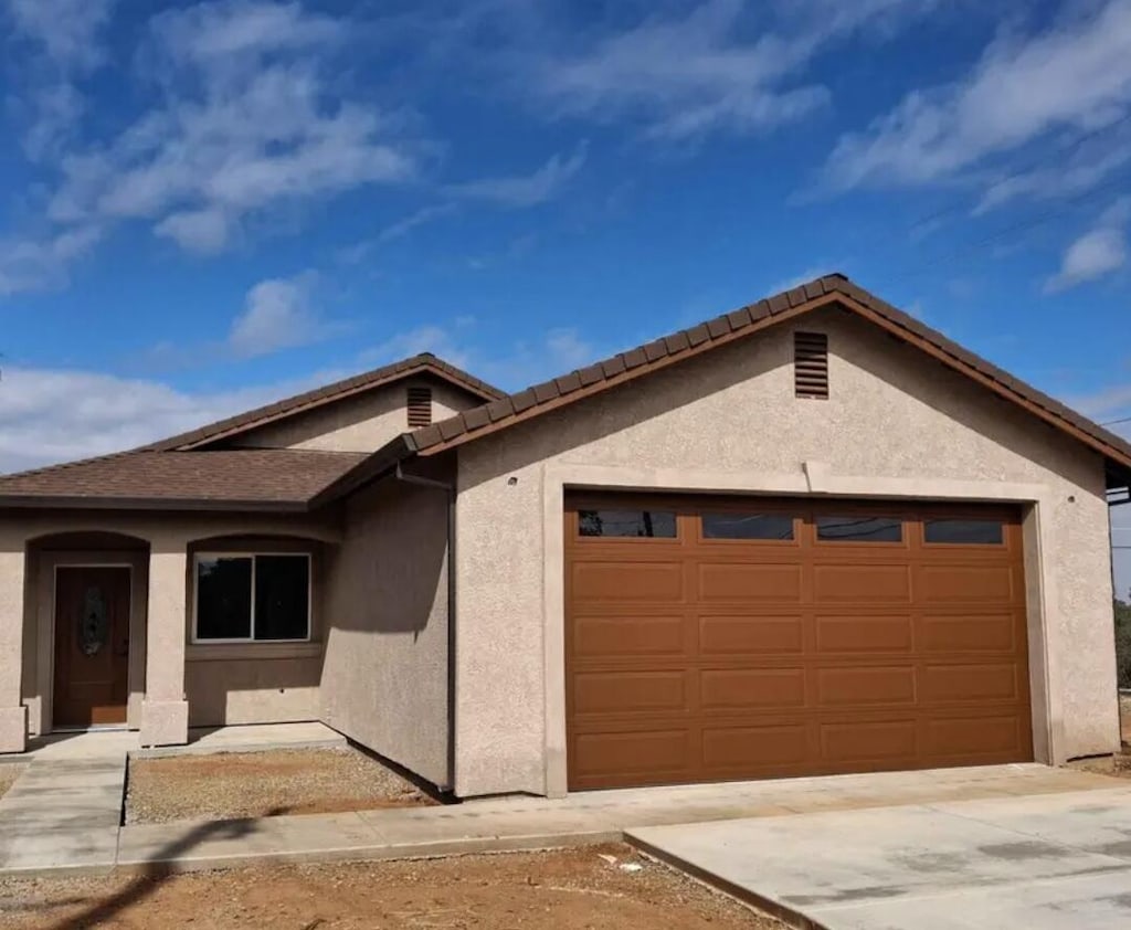 21870 Burney Pl, Cottonwood, CA 96022 - single story home featuring a garage, stucco siding, and concrete driveway