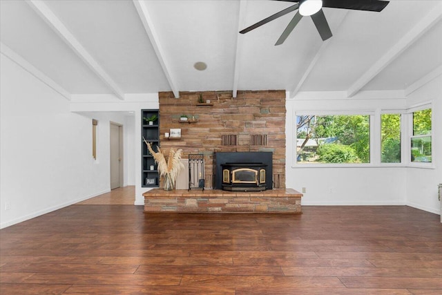 2551 S Waverly Ave, Redding, CA 96001 - unfurnished living room featuring a ceiling fan, a wood stove, hardwood / wood-style floors, and healthy amount of natural light