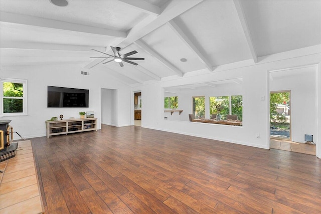 2551 S Waverly Ave, Redding, CA 96001 - living area with hardwood / wood-style floors, a wood stove, a ceiling fan, and baseboards