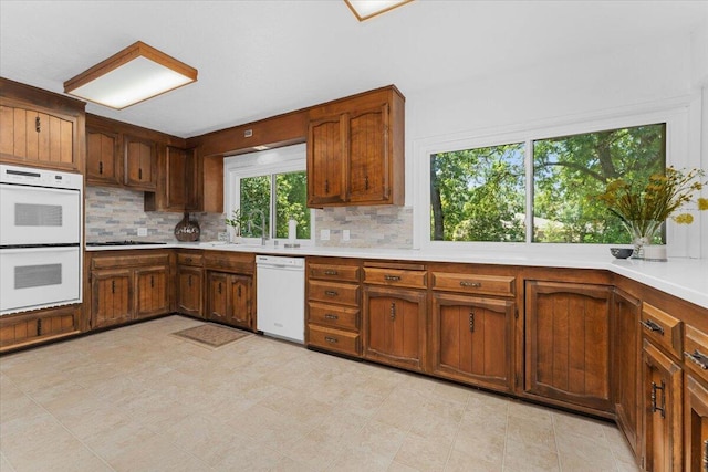 2551 S Waverly Ave, Redding, CA 96001 - kitchen with white appliances, light countertops, decorative backsplash, and a sink