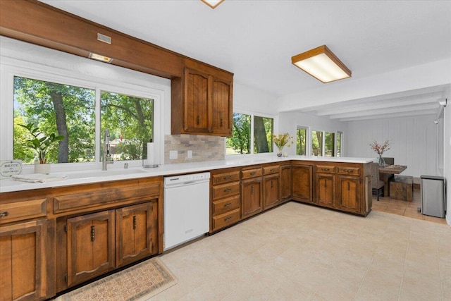 2551 S Waverly Ave, Redding, CA 96001 - kitchen featuring white dishwasher, a sink, light countertops, brown cabinets, and beam ceiling