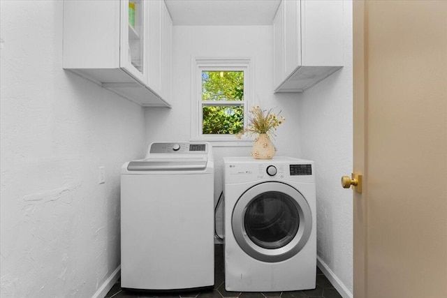 2551 S Waverly Ave, Redding, CA 96001 - laundry room featuring washing machine and clothes dryer, cabinet space, baseboards, dark tile patterned floors, and a textured wall
