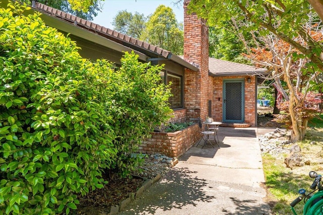 2551 S Waverly Ave, Redding, CA 96001 - property entrance featuring brick siding and a chimney