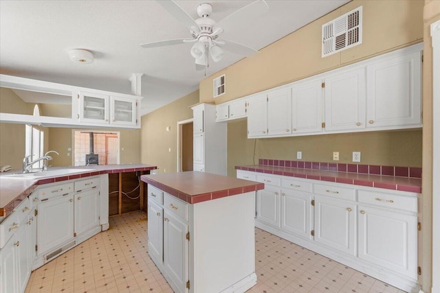 22400 E Elk Trl, Redding, CA 96003 - kitchen with light floors, a sink, and white cabinetry
