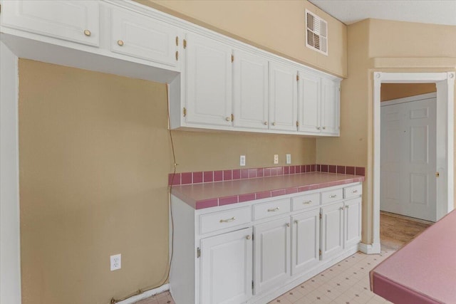 22400 E Elk Trl, Redding, CA 96003 - kitchen featuring light floors, white cabinets, and light countertops