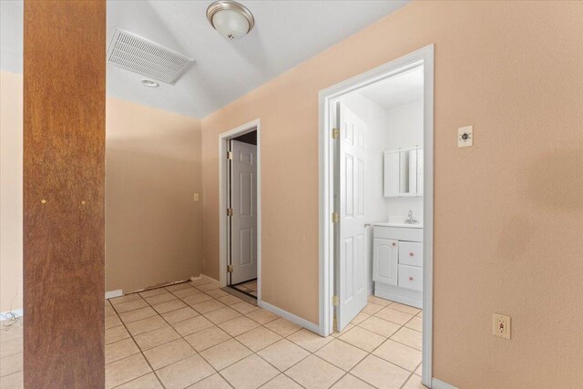 22400 E Elk Trl, Redding, CA 96003 - hall featuring light tile patterned floors, baseboards, and a sink