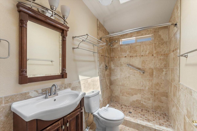 22400 E Elk Trl, Redding, CA 96003 - bathroom featuring vanity, tiled shower, toilet, tile walls, and wainscoting