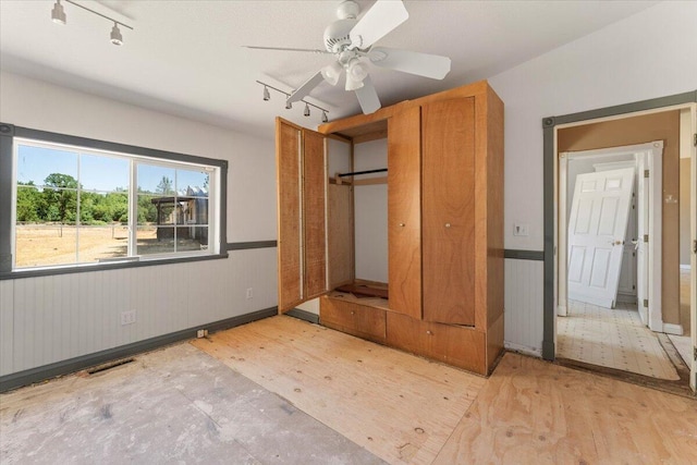 22400 E Elk Trl, Redding, CA 96003 - unfurnished bedroom featuring track lighting, wood finished floors, ceiling fan, and baseboards