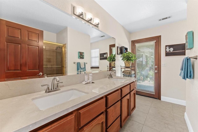 2364 La Madre Ct, Redding, CA 96002 - bathroom with baseboards, double vanity, healthy amount of natural light, and tile patterned flooring