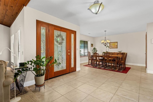 2364 La Madre Ct, Redding, CA 96002 - entryway featuring baseboards, a chandelier, and light tile patterned flooring