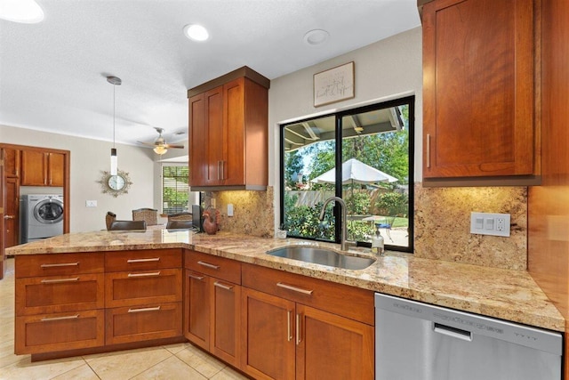 2364 La Madre Ct, Redding, CA 96002 - kitchen featuring stainless steel dishwasher, a sink, washer / dryer, light tile patterned flooring, and light stone countertops