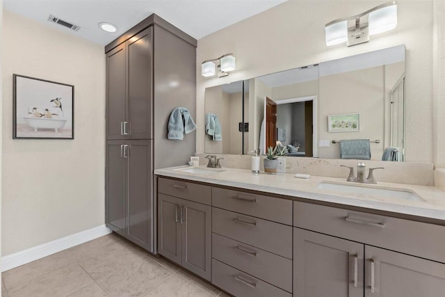 2364 La Madre Ct, Redding, CA 96002 - ensuite bathroom featuring double vanity, baseboards, and tile patterned flooring