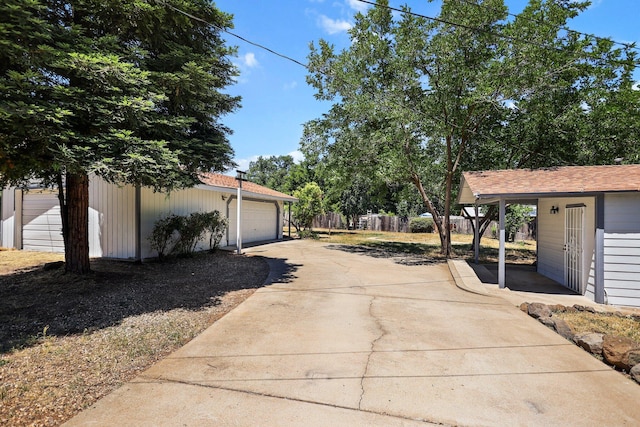 20650 Matamoros St, Redding, CA 96002 - view of yard featuring an outdoor structure, a garage, and concrete driveway