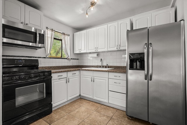 20650 Matamoros St, Redding, CA 96002 - kitchen featuring stainless steel appliances, dark countertops, a sink, white cabinetry, and light tile patterned floors