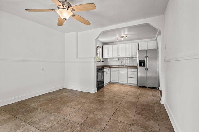 20650 Matamoros St, Redding, CA 96002 - kitchen featuring stainless steel fridge with ice dispenser, black gas stove, white cabinetry, backsplash, and a sink
