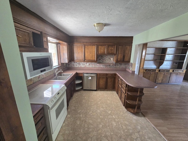 846 Ridge Rd, Redding, CA 96003 - kitchen featuring appliances with stainless steel finishes, a sink, a peninsula, open shelves, and a textured ceiling