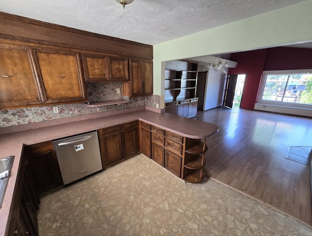 846 Ridge Rd, Redding, CA 96003 - kitchen with stainless steel dishwasher, a textured ceiling, open shelves, a chandelier, and a peninsula