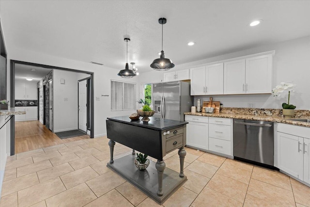 2220 Gold St, Redding, CA 96001 - kitchen with appliances with stainless steel finishes, white cabinetry, decorative light fixtures, light stone counters, and recessed lighting