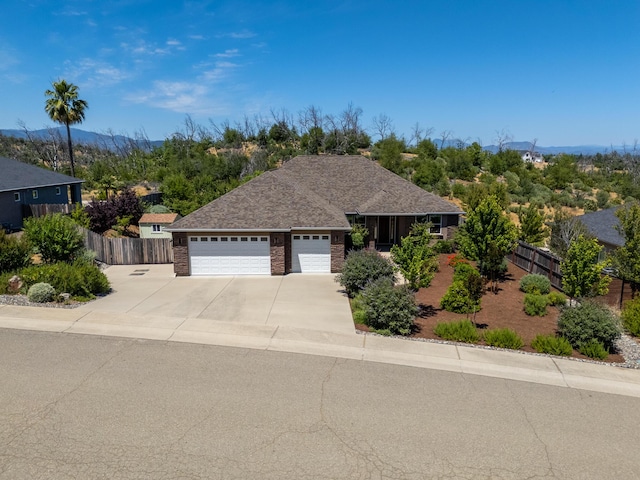4648 Kilkee Dr, Redding, CA 96001 - ranch-style home with an attached garage, driveway, brick siding, and roof with shingles