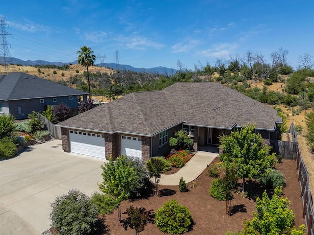 4648 Kilkee Dr, Redding, CA 96001 - ranch-style house featuring a garage, driveway, a mountain view, and brick siding