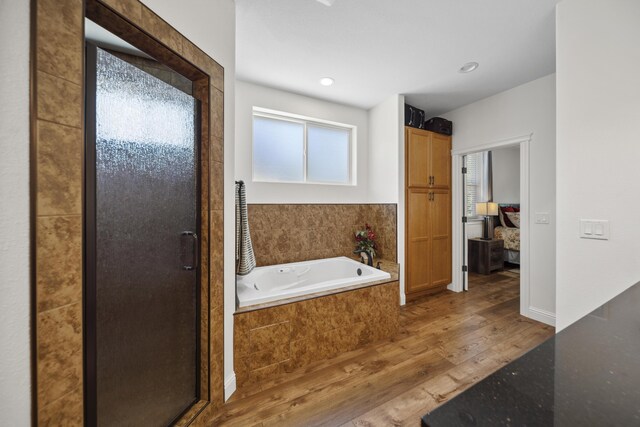 4648 Kilkee Dr, Redding, CA 96001 - full bath featuring wood finished floors, ensuite bath, a bath, and a stall shower