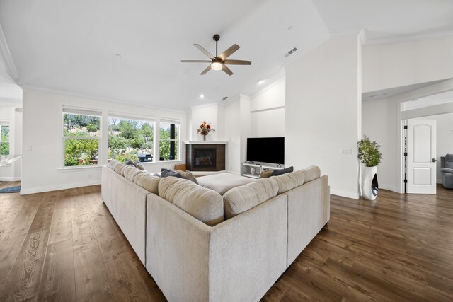 4648 Kilkee Dr, Redding, CA 96001 - living room with ceiling fan, dark wood finished floors, ornamental molding, a fireplace, and baseboards