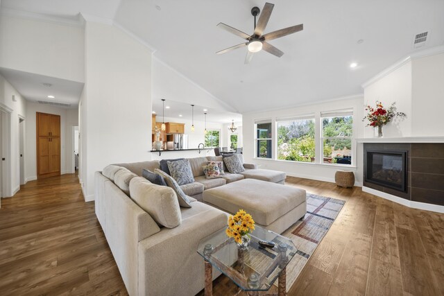 4648 Kilkee Dr, Redding, CA 96001 - living room featuring ceiling fan, wood finished floors, a fireplace, high vaulted ceiling, and baseboards