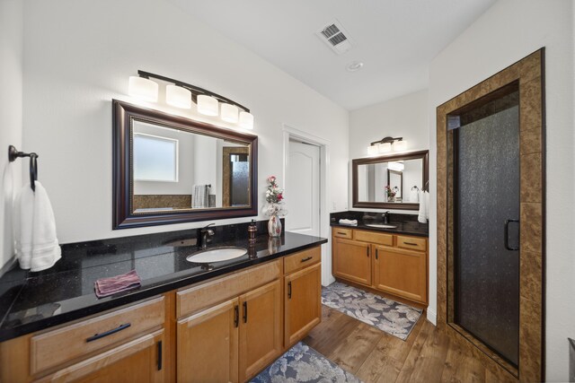 4648 Kilkee Dr, Redding, CA 96001 - full bath with two vanities, wood finished floors, and a stall shower