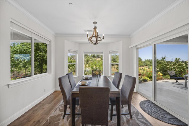 4648 Kilkee Dr, Redding, CA 96001 - dining space with wood finished floors, a chandelier, baseboards, and crown molding