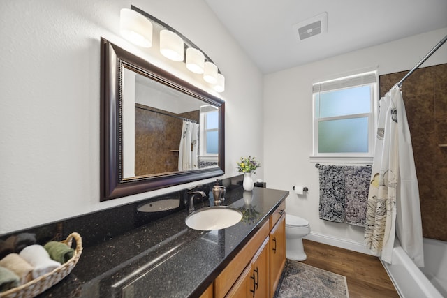 4648 Kilkee Dr, Redding, CA 96001 - bathroom with vanity, toilet, wood finished floors, and shower / bath combo with shower curtain