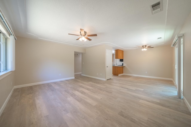 5867 Bell Rd, Redding, CA 96001 - unfurnished living room featuring a ceiling fan, light wood finished floors, and baseboards