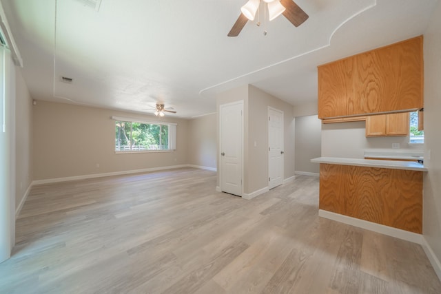 5867 Bell Rd, Redding, CA 96001 - unfurnished living room with a ceiling fan, light wood-type flooring, and baseboards
