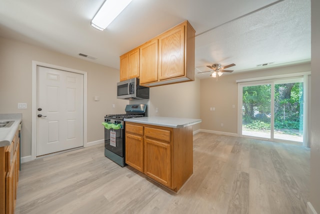 5867 Bell Rd, Redding, CA 96001 - kitchen featuring appliances with stainless steel finishes, light wood-type flooring, ceiling fan, and light countertops